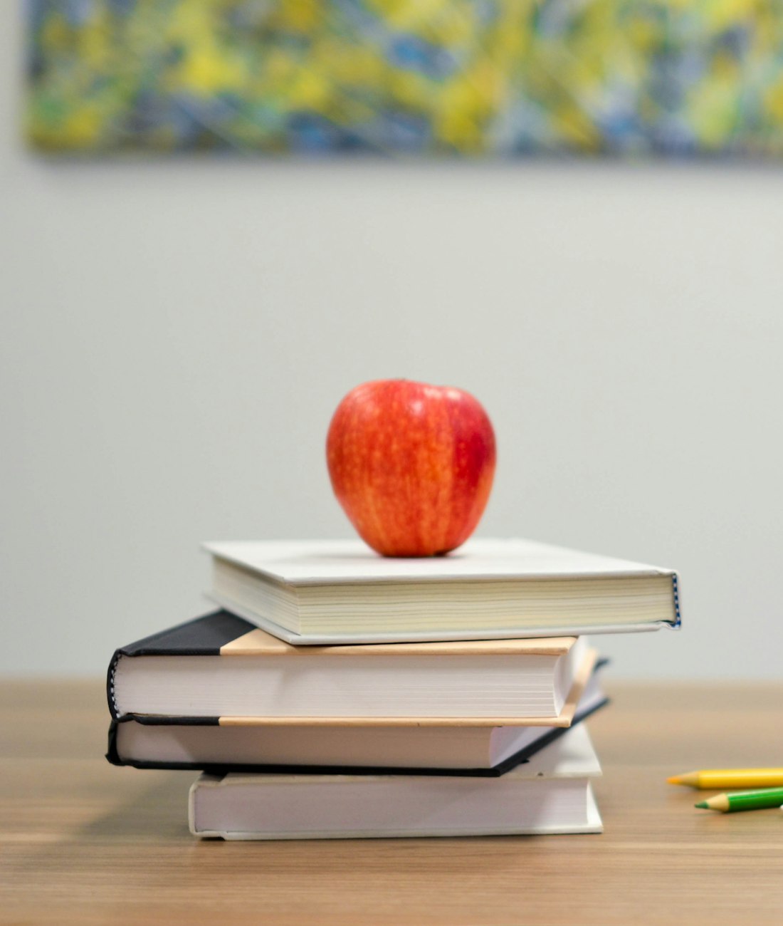 An open notebook and book on a quiet study desk in warm light